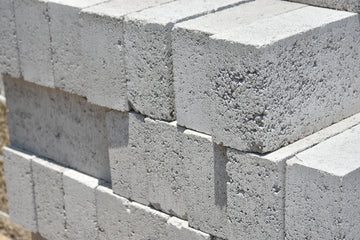 a stack of cinder blocks sitting on top of a sidewalk